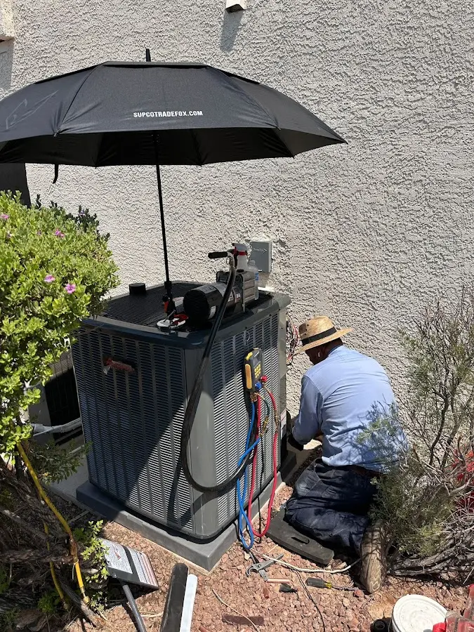 HVAC technician performing outdoor AC maintenance in Everman